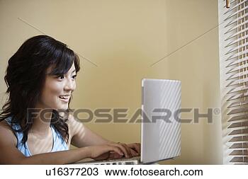 Stock Photo - young woman playing 
with laptop. fotosearch 
- search stock 
photos, pictures, 
images, and photo 
clipart