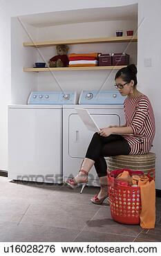 Stock Photo - young woman sitting 
and playing laptop. 
fotosearch - search 
stock photos, 
pictures, images, 
and photo clipart