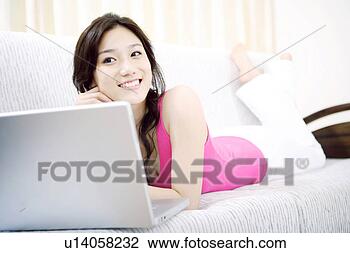 Stock Photo - young woman in 
sofa with laptop. 
fotosearch - search 
stock photos, 
pictures, images, 
and photo clipart