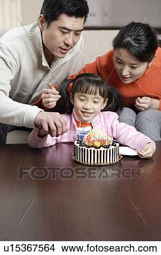 Stock Photo - father and mother 
cutting cake with 
daughter. fotosearch 
- search stock 
photos, pictures, 
images, and photo 
clipart