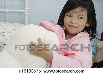 Stock Image - girl in bath gown 
holding a quilt. 
fotosearch - search 
stock photos, 
pictures, images, 
and photo clipart