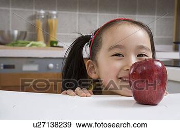 Stock Photograph - girl behind red 
apple. fotosearch 
- search stock 
photos, pictures, 
images, and photo 
clipart