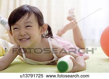 Stock Image - girl holding milk 
bottle in bed, 
smiling. fotosearch 
- search stock 
photos, pictures, 
images, and photo 
clipart
