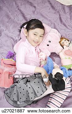 Picture - girl playing with 
dolls in bed. 
fotosearch - search 
stock photos, 
pictures, images, 
and photo clipart