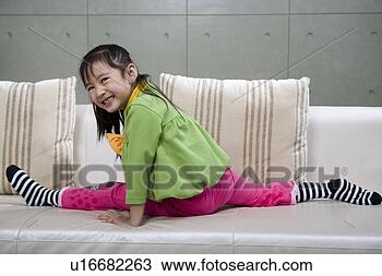 Stock Photo - girl playing in 
sofa. fotosearch 
- search stock 
photos, pictures, 
images, and photo 
clipart