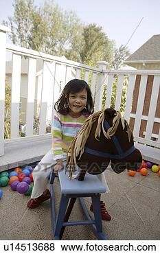 Stock Photo - girl riding on 
a wooden horse. 
fotosearch - search 
stock photos, 
pictures, images, 
and photo clipart