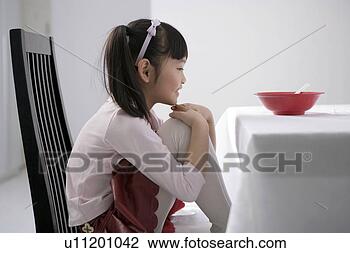 Stock Photo - girl sitting at 
the dinning table. 
fotosearch - search 
stock photos, 
pictures, images, 
and photo clipart