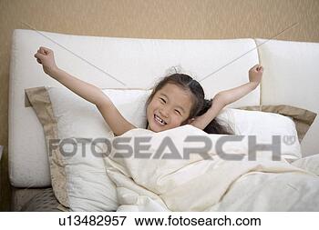 Picture - girl smiling in 
bedclothes. fotosearch 
- search stock 
photos, pictures, 
images, and photo 
clipart