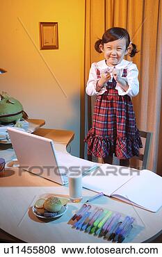 Stock Photo - girl smiling behind 
laptop. fotosearch 
- search stock 
photos, pictures, 
images, and photo 
clipart