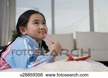 Stock Photo - girl thinking, 
holding a pencil. 
fotosearch - search 
stock photos, 
pictures, images, 
and photo clipart