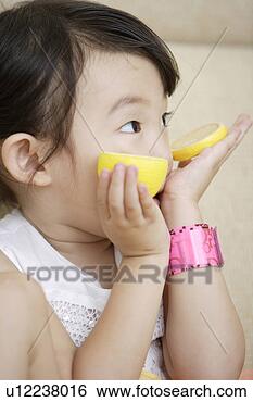 Stock Photo - gril holding lemon 
slices. fotosearch 
- search stock 
photos, pictures, 
images, and photo 
clipart