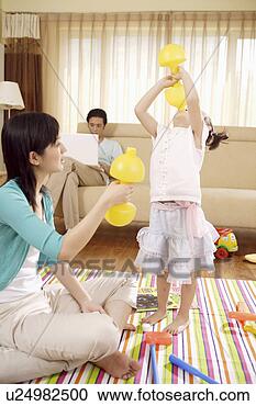 Stock Photography - mother and daughter 
drinking with 
yellow bottles. 
fotosearch - search 
stock photos, 
pictures, images, 
and photo clipart