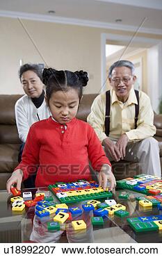 Picture - senior couple 
playing spelling 
game with granddaughter. 
fotosearch - search 
stock photos, 
pictures, images, 
and photo clipart