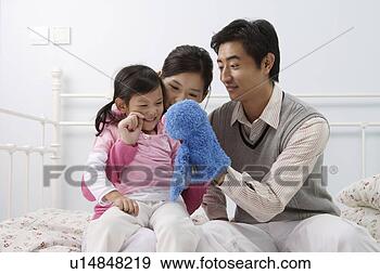 Stock Photograph - young family playing 
with puppet. fotosearch 
- search stock 
photos, pictures, 
images, and photo 
clipart