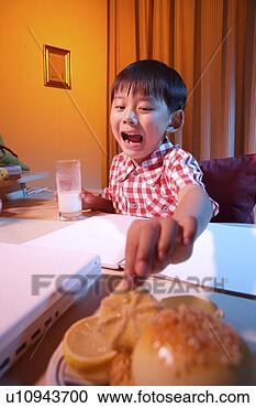 Stock Photography - boy drinking milk 
and eating bread. 
fotosearch - search 
stock photos, 
pictures, images, 
and photo clipart