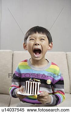 Stock Image - boy eating cake. 
fotosearch - search 
stock photos, 
pictures, images, 
and photo clipart