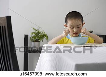 Stock Photo - boy eating with 
chopsticks. fotosearch 
- search stock 
photos, pictures, 
images, and photo 
clipart