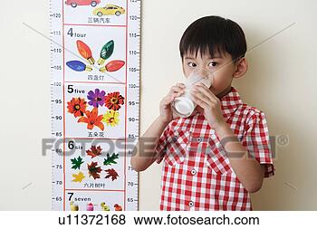 Stock Photo - boy holding a 
glass of milk 
beside height 
ruler. fotosearch 
- search stock 
photos, pictures, 
images, and photo 
clipart
