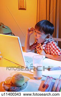 Stock Photo - boy looking at 
laptop. fotosearch 
- search stock 
photos, pictures, 
images, and photo 
clipart