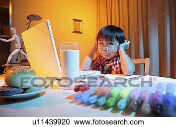 Stock Photography - boy making face 
at desk with laptop. 
fotosearch - search 
stock photos, 
pictures, images, 
and photo clipart