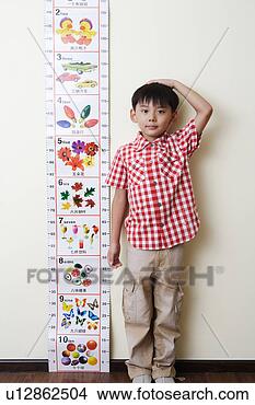 Stock Photo - boy measuring 
his height. fotosearch 
- search stock 
photos, pictures, 
images, and photo 
clipart