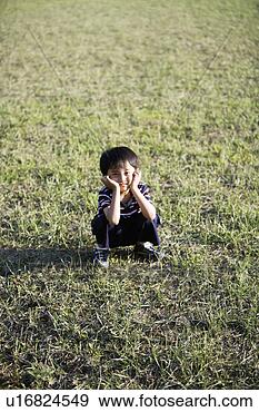 Stock Photograph - boy smiling on 
lawn. fotosearch 
- search stock 
photos, pictures, 
images, and photo 
clipart