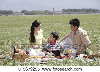 Stock Image - family having 
picnic on lawn. 
fotosearch - search 
stock photos, 
pictures, images, 
and photo clipart