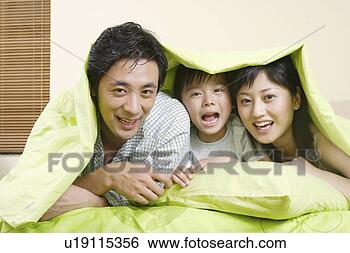 Stock Photo - family members 
in quilt with 
smile. fotosearch 
- search stock 
photos, pictures, 
images, and photo 
clipart