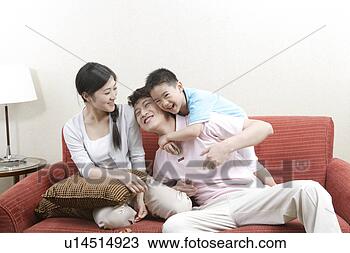 Stock Photo - family playing 
in sofa. fotosearch 
- search stock 
photos, pictures, 
images, and photo 
clipart