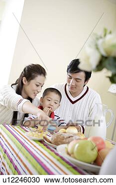 Stock Photography - family sharing 
food and milk. 
fotosearch - search 
stock photos, 
pictures, images, 
and photo clipart