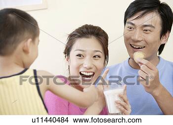 Stock Photo - family sharing 
milk and cookie. 
fotosearch - search 
stock photos, 
pictures, images, 
and photo clipart
