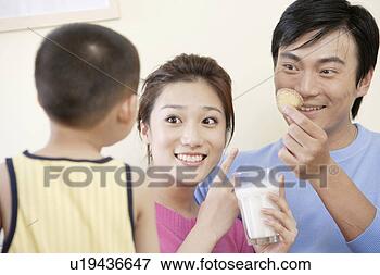 Picture - family sharing 
milk and cookie. 
fotosearch - search 
stock photos, 
pictures, images, 
and photo clipart