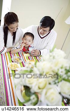 Stock Photo - family sharing 
snack. fotosearch 
- search stock 
photos, pictures, 
images, and photo 
clipart