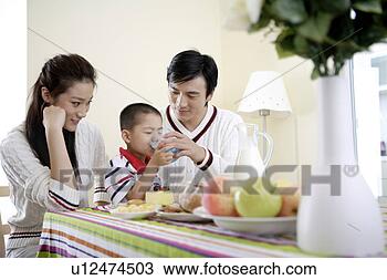 Stock Photo - parents feeding 
milk to son. fotosearch 
- search stock 
photos, pictures, 
images, and photo 
clipart