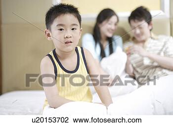 Stock Photo - parents and son 
in bed. fotosearch 
- search stock 
photos, pictures, 
images, and photo 
clipart