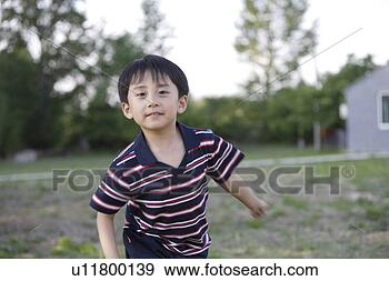 Stock Photograph - a portrait of 
running boy. fotosearch 
- search stock 
photos, pictures, 
images, and photo 
clipart