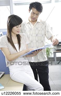 Stock Image - office man and 
woman looking 
at files in office. 
fotosearch - search 
stock photos, 
pictures, images, 
and photo clipart