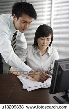 Stock Photo - office man and 
woman looking 
at pc in office. 
fotosearch - search 
stock photos, 
pictures, images, 
and photo clipart