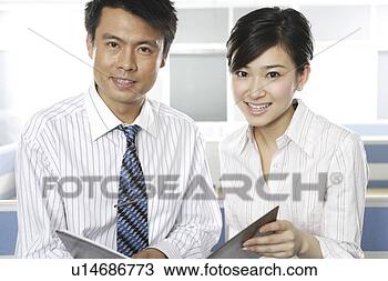 Stock Photo - office man and 
woman looking 
at files in office. 
fotosearch - search 
stock photos, 
pictures, images, 
and photo clipart