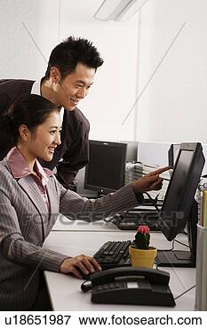 Picture - office man and 
woman looking 
at pc. fotosearch 
- search stock 
photos, pictures, 
images, and photo 
clipart