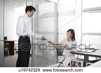 Stock Photograph - office woman giving 
a file to office 
man. fotosearch 
- search stock 
photos, pictures, 
images, and photo 
clipart