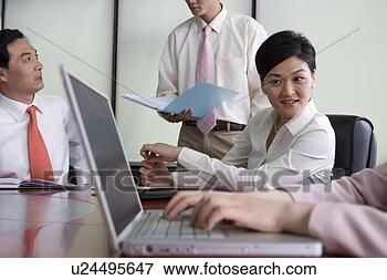 Picture - office woman looking 
at laptop. fotosearch 
- search stock 
photos, pictures, 
images, and photo 
clipart