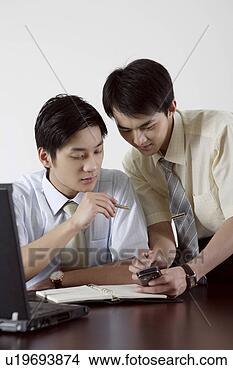 Stock Photo - two business men 
playing with cellphone. 
fotosearch - search 
stock photos, 
pictures, images, 
and photo clipart