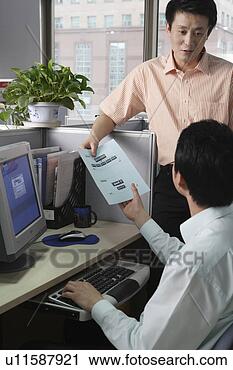 Stock Photography - young man handing 
files to another 
young man at office. 
fotosearch - search 
stock photos, 
pictures, images, 
and photo clipart