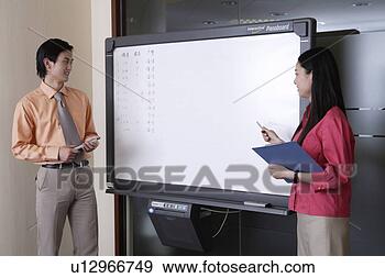 Stock Photograph - young man and 
young woman with 
tablet. fotosearch 
- search stock 
photos, pictures, 
images, and photo 
clipart
