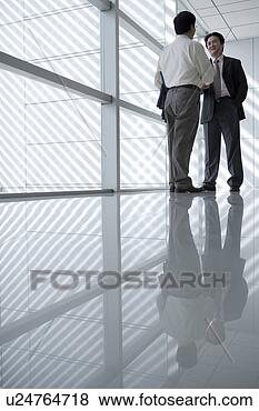 Stock Photo - young men hand 
shaking near window. 
fotosearch - search 
stock photos, 
pictures, images, 
and photo clipart