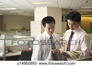 Stock Photo - young men reading 
at office. fotosearch 
- search stock 
photos, pictures, 
images, and photo 
clipart