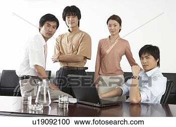 Stock Photography - young men and 
young women standing 
and sitting at 
office. fotosearch 
- search stock 
photos, pictures, 
images, and photo 
clipart