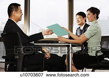 Picture - young woman giving 
file to young 
man. fotosearch 
- search stock 
photos, pictures, 
images, and photo 
clipart