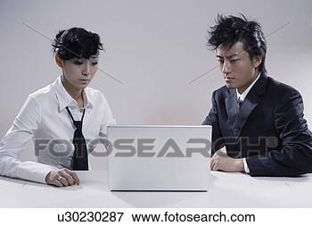 Picture - young woman and 
young man looking 
at laptop. fotosearch 
- search stock 
photos, pictures, 
images, and photo 
clipart